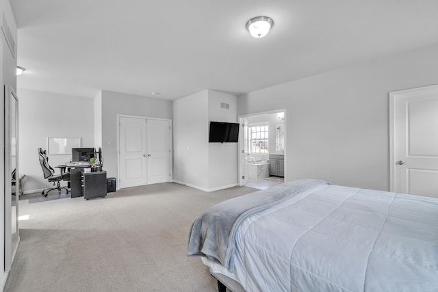 bedroom with baseboards, visible vents, connected bathroom, light colored carpet, and a closet