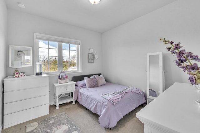 bedroom with light colored carpet