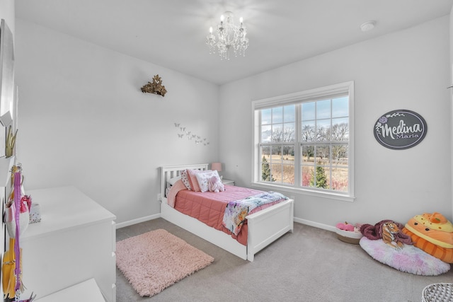 bedroom with carpet, baseboards, and an inviting chandelier