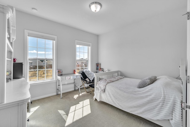 bedroom with carpet floors and baseboards