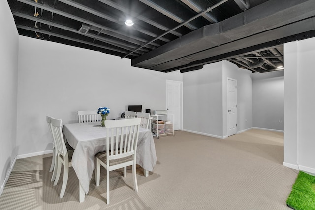 carpeted dining room with baseboards