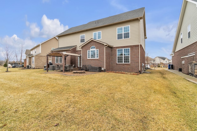 back of property featuring an outdoor fire pit, a lawn, a patio, a gazebo, and brick siding