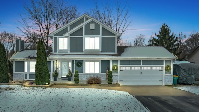 view of front facade with a garage, concrete driveway, brick siding, and a chimney