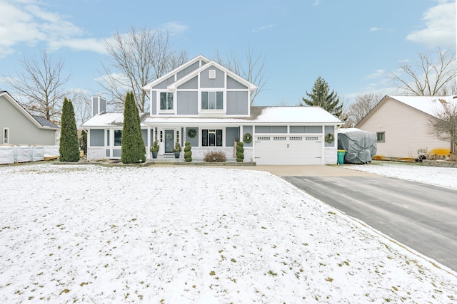 view of front facade with a garage, fence, and concrete driveway