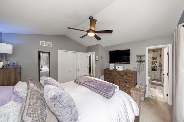 carpeted bedroom featuring ceiling fan, ensuite bathroom, visible vents, vaulted ceiling, and a closet