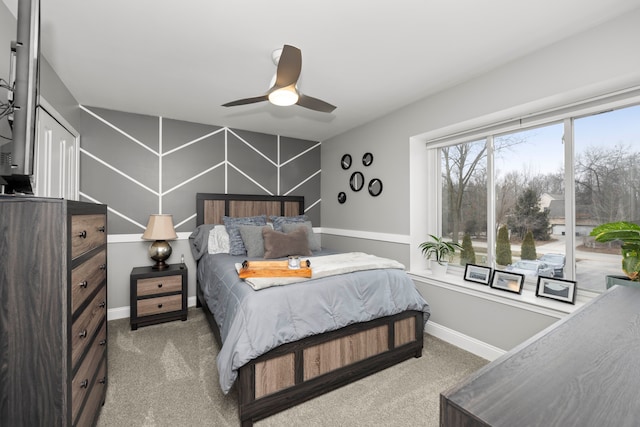 carpeted bedroom featuring a ceiling fan and baseboards