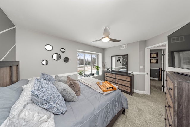 bedroom featuring baseboards, visible vents, a ceiling fan, and light colored carpet