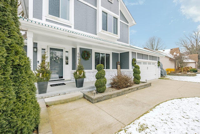 view of front of property featuring a garage, driveway, and stucco siding