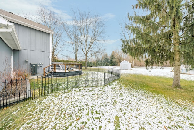 view of yard featuring a storage unit, an outdoor structure, and fence