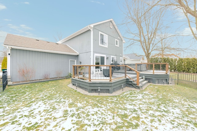 back of property featuring fence, a deck, and a yard