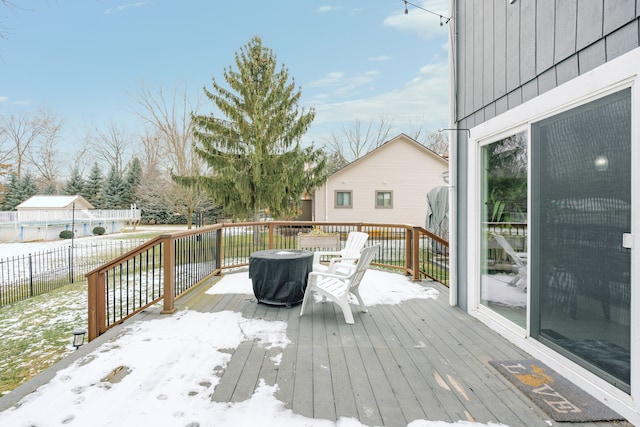 snow covered deck with fence