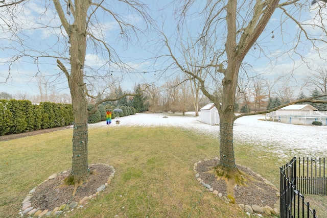 view of yard with a storage unit, an outdoor structure, and fence