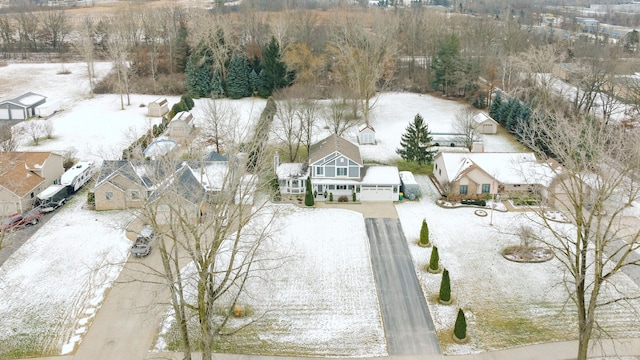 snowy aerial view featuring a residential view