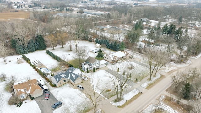 snowy aerial view with a residential view