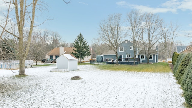 view of yard with a deck, a storage unit, an outdoor structure, and fence