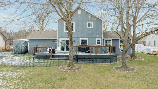 back of property featuring a yard, a wooden deck, and fence