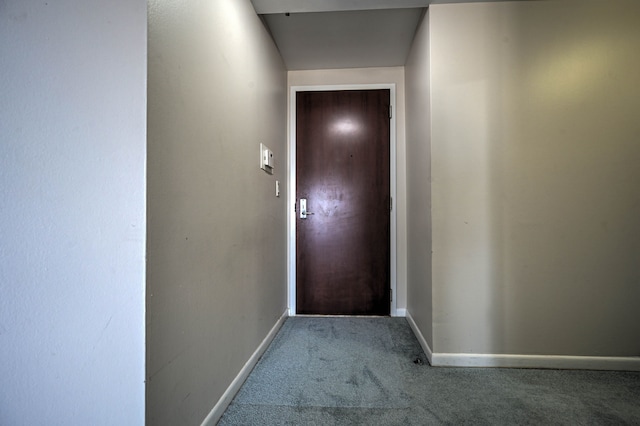 doorway to outside featuring carpet and baseboards