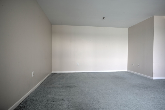 carpeted empty room with baseboards