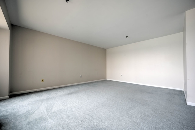 spare room with carpet floors and baseboards