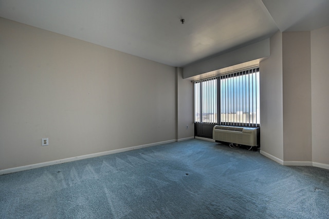 carpeted empty room with a wall mounted air conditioner and baseboards