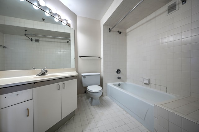 bathroom featuring shower / washtub combination, vanity, toilet, and tile patterned floors