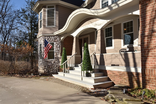 property entrance featuring brick siding and stone siding