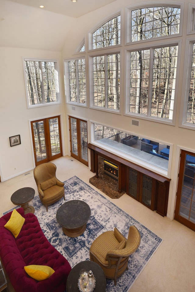 interior space with visible vents, french doors, and vaulted ceiling