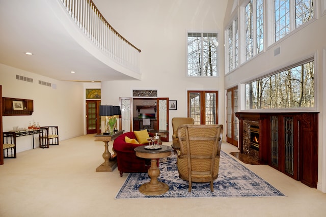 living area with french doors, visible vents, and a healthy amount of sunlight