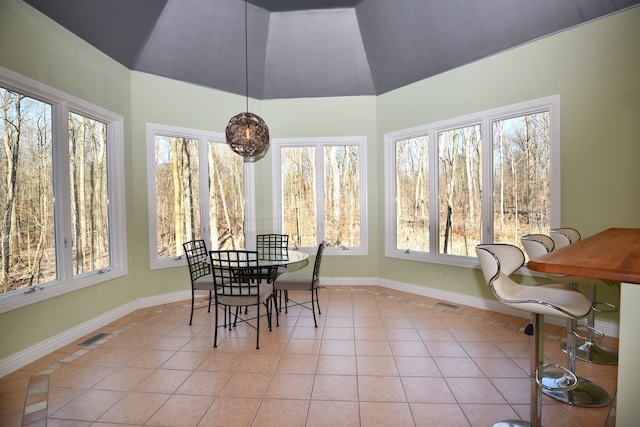 sunroom featuring visible vents and lofted ceiling