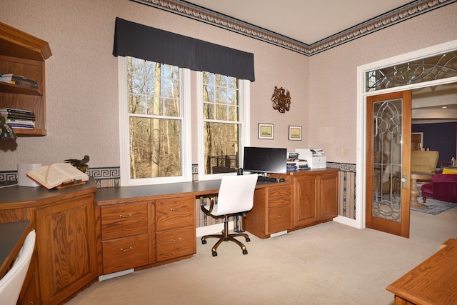 home office with light carpet, french doors, and wallpapered walls