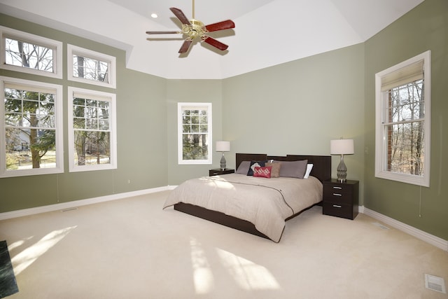 bedroom with baseboards, light carpet, visible vents, and ceiling fan