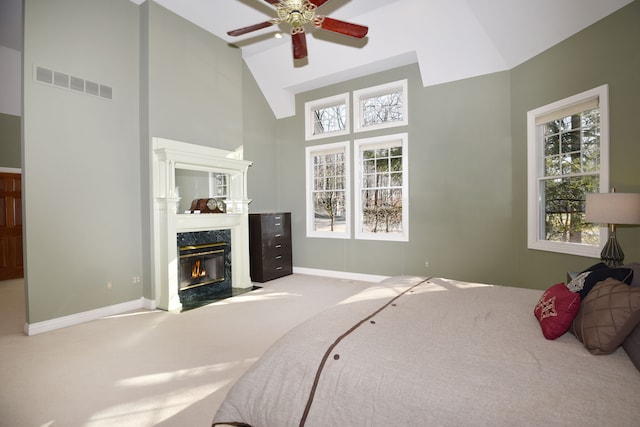 bedroom with carpet flooring, multiple windows, a fireplace, and visible vents