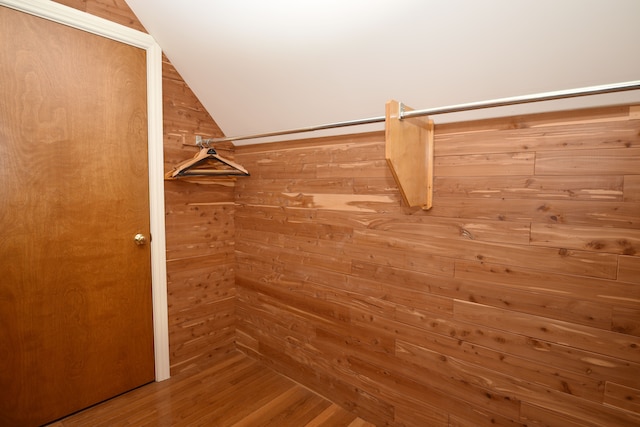 spacious closet featuring wood finished floors and vaulted ceiling