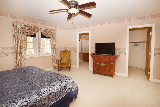 carpeted bedroom featuring a spacious closet, visible vents, ceiling fan, baseboards, and a closet