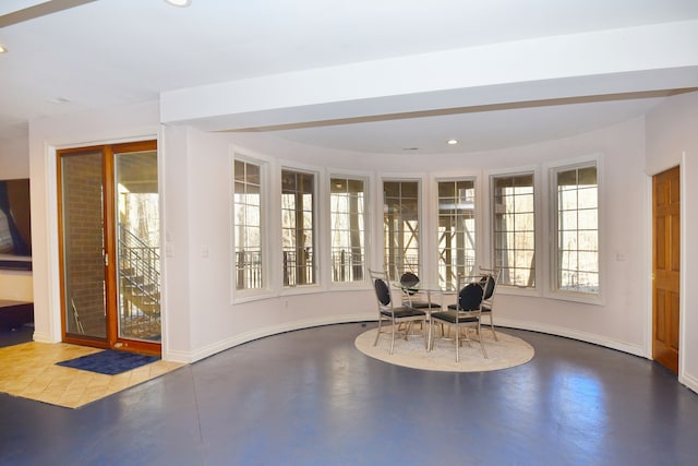 unfurnished dining area featuring recessed lighting, concrete floors, and baseboards