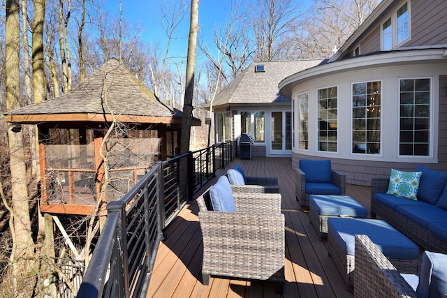 deck featuring a gazebo, area for grilling, and an outdoor living space