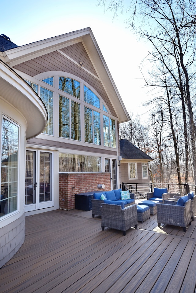 wooden deck featuring french doors and outdoor lounge area