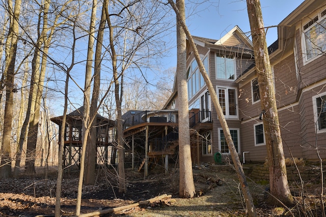 rear view of property featuring a wooden deck