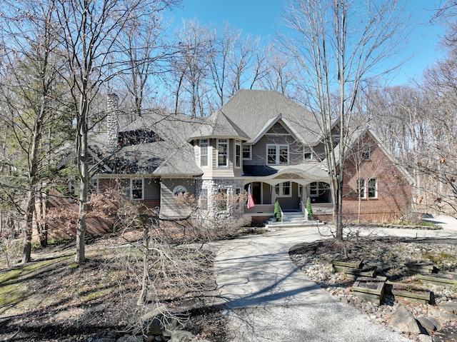 view of front of home featuring brick siding and driveway