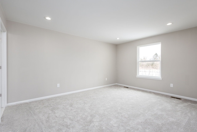 empty room with baseboards, carpet floors, and recessed lighting