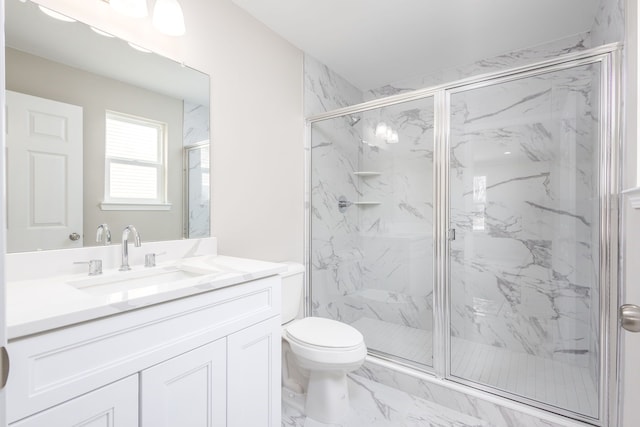 bathroom with marble finish floor, toilet, vanity, and a marble finish shower