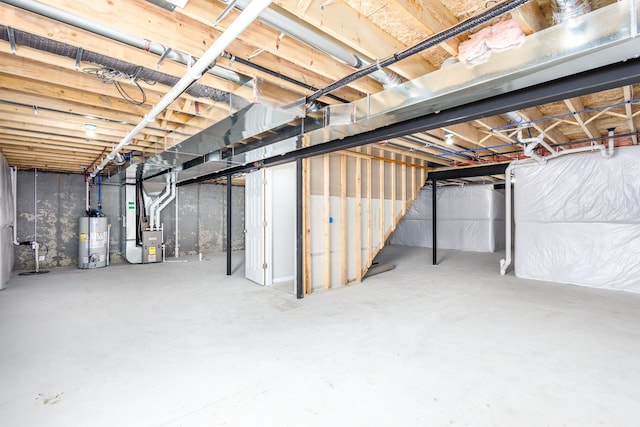 unfinished basement with water heater and heating unit