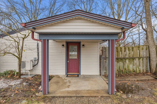 property entrance with ac unit and fence