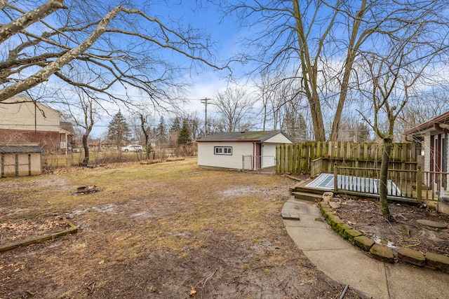 view of yard with fence and an outdoor structure