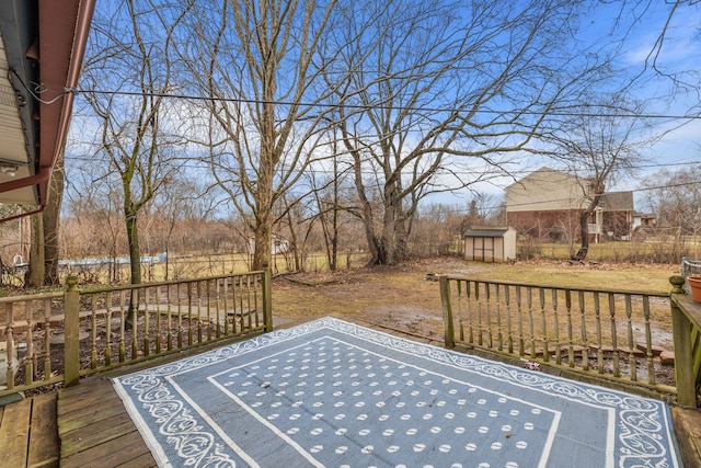 wooden deck with a storage shed, fence, and an outdoor structure