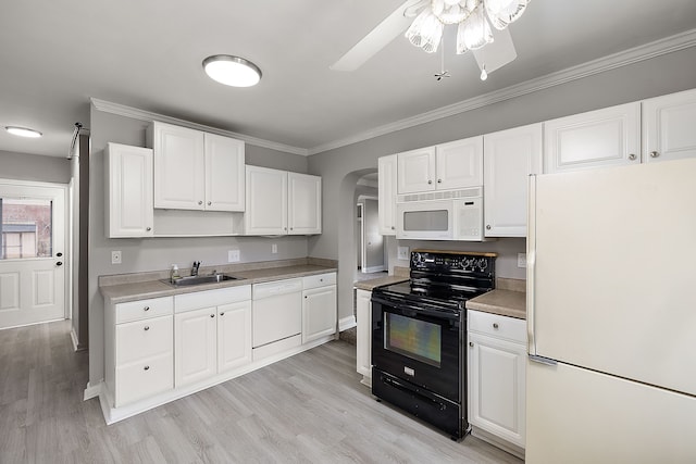 kitchen with crown molding, arched walkways, white appliances, and a sink