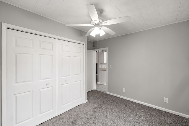 unfurnished bedroom featuring a ceiling fan, carpet, baseboards, and a closet