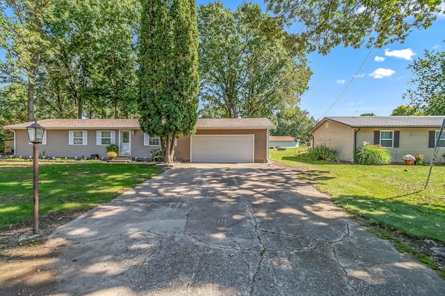 ranch-style house featuring a garage, driveway, and a front yard