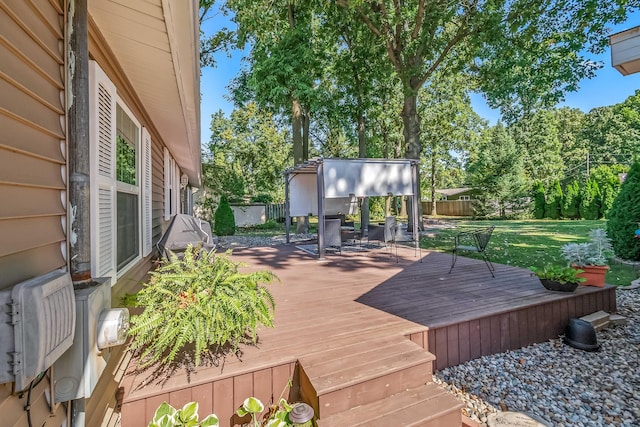 deck with fence, an outbuilding, and a yard