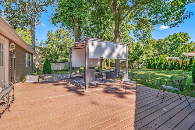 wooden deck featuring a lawn